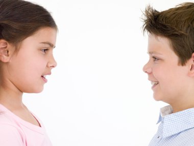 Brother and sister looking at each other smiling clipart