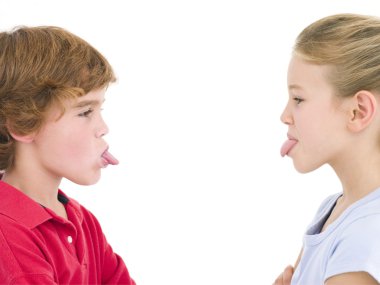 Brother and sister sticking tongues out at each other clipart
