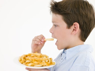 Young boy eating French fries clipart