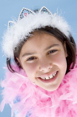 Young girl wearing crown and feather boa smiling clipart