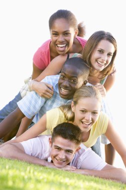 Group Of Teenagers Having Fun Outdoors clipart