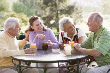 Friends Enjoying A Beverage By A Golf Course clipart