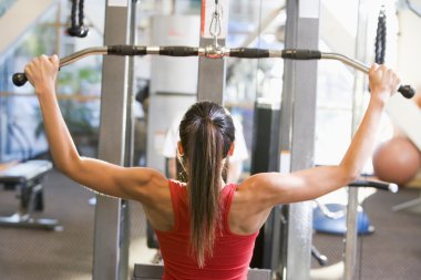 Woman Weight Training At Gym clipart