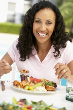 Middle Aged Woman Dining Al Fresco clipart