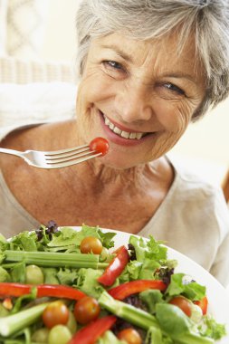 Senior Woman Eating Healthy Salad clipart