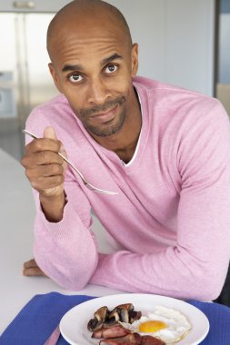 Middle Aged Man Eating Unhealthy Fried Breakfast clipart