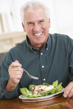 Senior Man Eating A Healthy Meal clipart