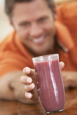 Middle Aged Man Drinking Fresh Berry Smoothie clipart