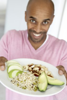 Middle Aged Man Holding Out A Plate With Healthy Foods clipart