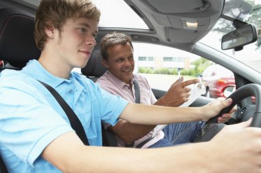 Teenage Boy Taking A Driving Lesson clipart