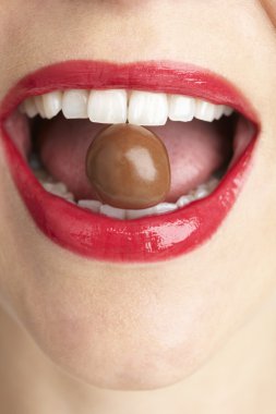 Woman Biting Chocolate clipart