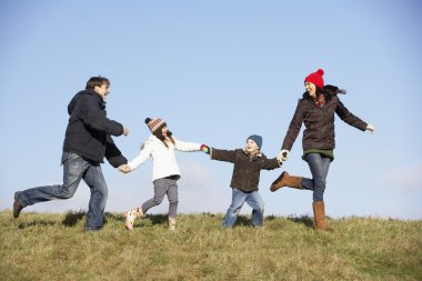 Family Running In The Park clipart