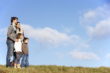 Family Standing In The Park clipart