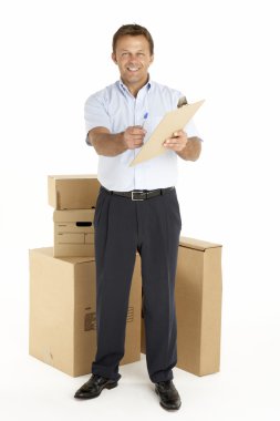 Portrait Of Courier Standing Next To Parcels, Holding A Clipboar clipart