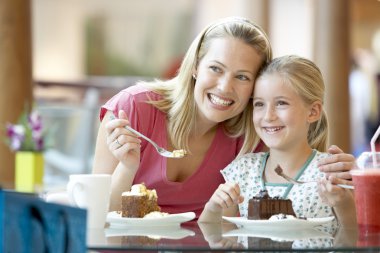 Mother And Daughter Having Lunch Together At The Mall clipart