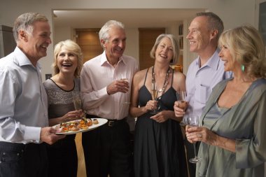 Man Serving Hors D'oeuvres To His Guests At A Dinner Party clipart