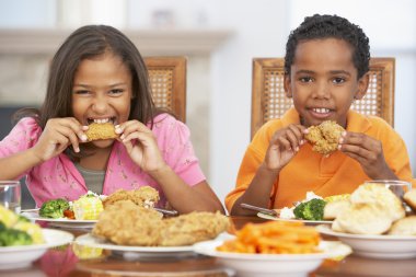 Brother And Sister Having Lunch Together At Home clipart