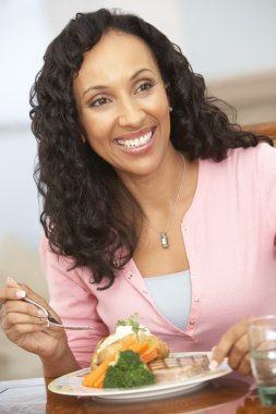 Woman Enjoying A Meal At Home clipart