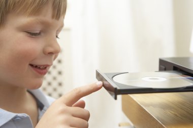 Young Boy Closing DVD Player With Finger clipart