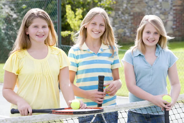 Drei Junge Freundinnen Mit Schlägern Auf Dem Tennisplatz Lächeln — Stockfoto