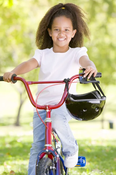 Bisiklet dışarıda gülümseyen genç kız — Stok fotoğraf