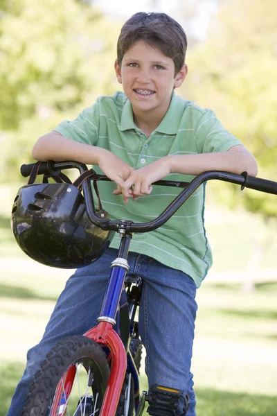 Young boy on bicycle outdoors smiling — Stock Photo, Image