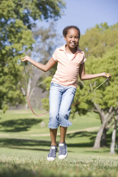 Young Girl Using Skipping Rope Outdoors Smiling — Stock Photo, Image