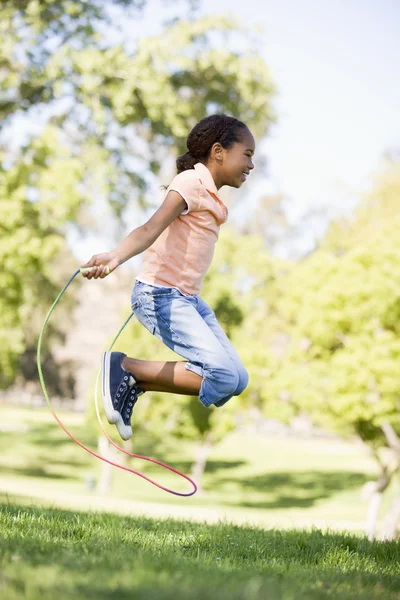 Young Girl Using Skipping Rope Outdoors Smiling — Stock Photo, Image