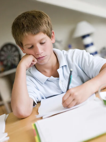 年轻的男孩做在他的房间中的作业 — 图库照片