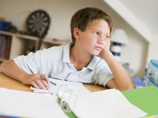 Giovane ragazzo fare i compiti nella sua stanza — Foto Stock