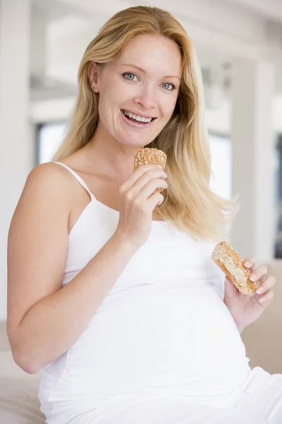 Pregnant Woman Eating Bread Smiling — Stock Photo, Image