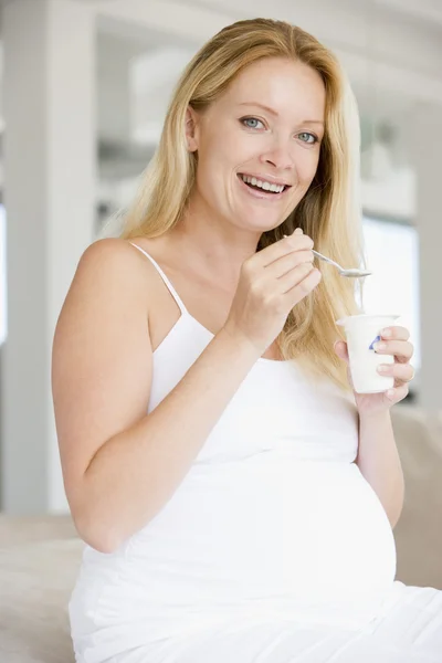 Zwangere vrouw met yoghurt lachende — Stockfoto