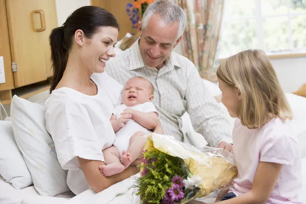 New parents with baby talking — Stock Photo, Image
