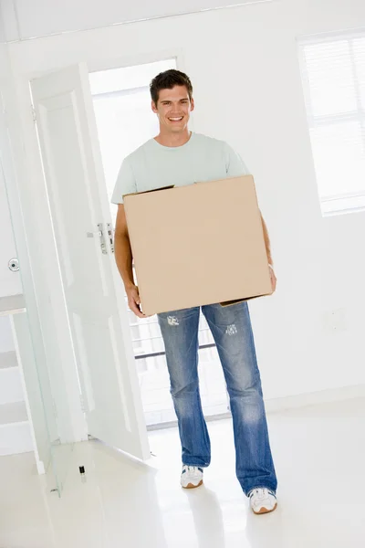 Mann Mit Kiste Zieht Lächelnd Neues Zuhause Ein — Stockfoto