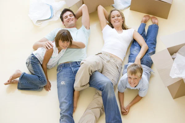 Family Lying Floor Open Boxes New Home Smiling — Stock Photo, Image