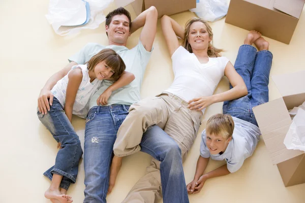 Family Lying Floor Open Boxes New Home Smiling — Stock Photo, Image