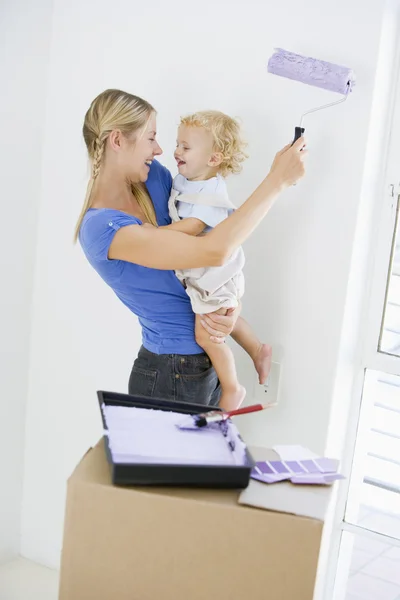Mother Holding Son While Painting Room New Home Smiling — Stock Photo, Image