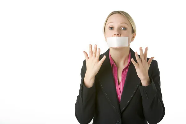Mujer de negocios con la boca cerrada con cinta — Foto de Stock