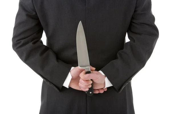 Geschäftsmann hält Messer hinter dem Rücken — Stockfoto