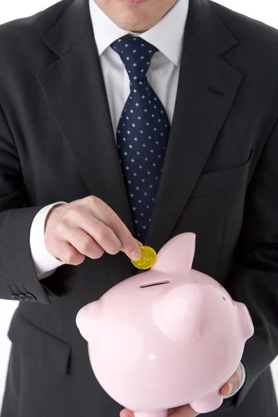 Empresário Colocando Moeda Piggy Bank — Fotografia de Stock