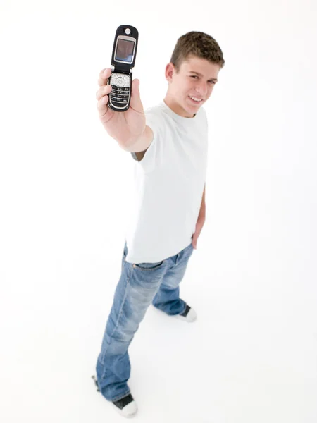Tizenéves fiú feltartotta: sejtes telefon és mosolyogva — Stock Fotó
