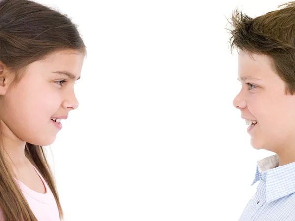 Brother and sister looking at each other smiling — Stock Photo, Image