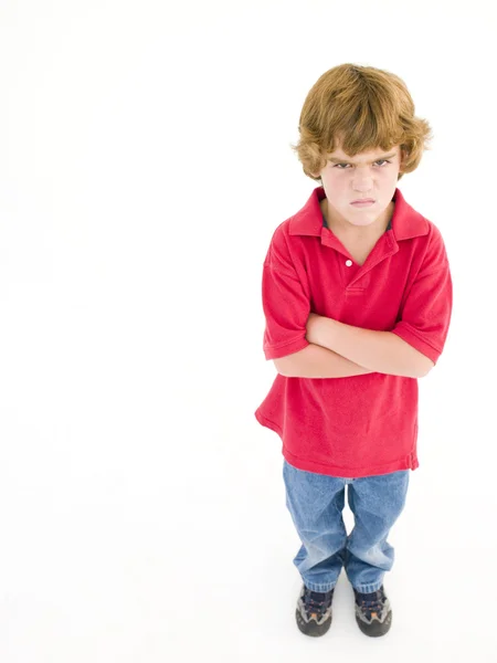 Ung pojke med armarna korsade arg — Stockfoto