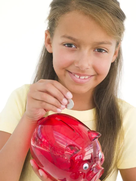 Young Girl Putting Coin Piggy Bank Smiling — Stock Photo, Image