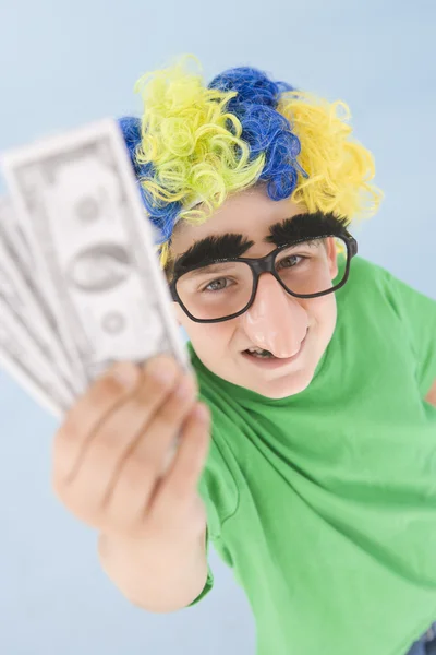 Niño vistiendo peluca de payaso y nariz falsa sosteniendo dinero —  Fotos de Stock