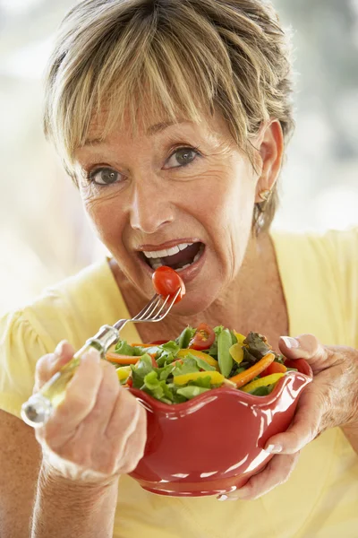 Mulher sênior comendo salada fresca — Fotografia de Stock