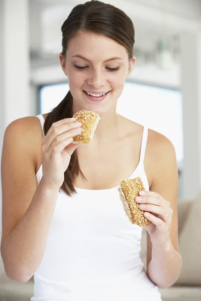 Young Woman Eating Brown Bread Roll — Stock Photo, Image