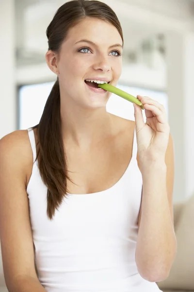 Young Woman Eating Celery Sticks — Stock Photo, Image