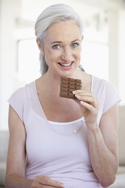 Senior Woman Eating Chocolate — Stock Photo, Image