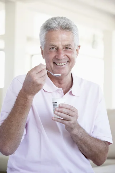 中间岁的男子吃酸奶 — 图库照片